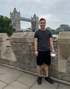 Alex Clausius in London with London bridge in background