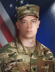 Brandon Feathers in U.S. Army uniform in front of U.S. flag background