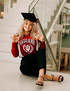 Shelby Cleek smiling with graduation cap and IU shirt